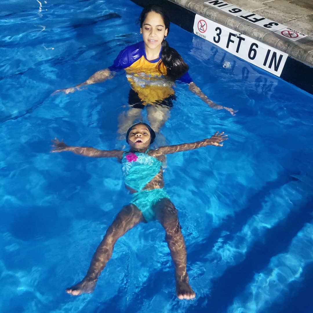 A woman and child in the pool